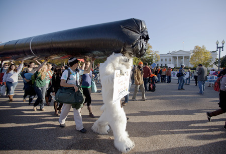 Protesters carry a replica of Keystone XL oil pipeline to protest increasing the amount of oil flow from tar sands, Alberta, Canada.