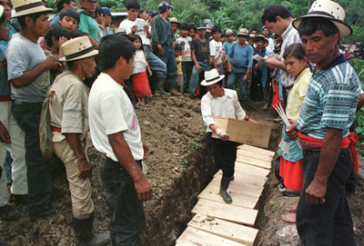 Mayan men bury victims of a 1982 massacre in a mass grave in Chel, a remote village  in northern Guatemala on July 4, 1998.
