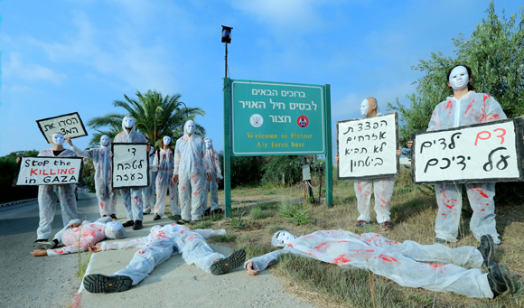 Israeli activists protest at an Air Force base against the attack on Gaza