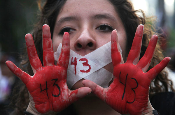 Protester holds up her red-painted hands and the number 43 written on them referring to the 43 missing students from the Isidro Burgos rural teachers college in Mexico City, December 26. Photo-AP