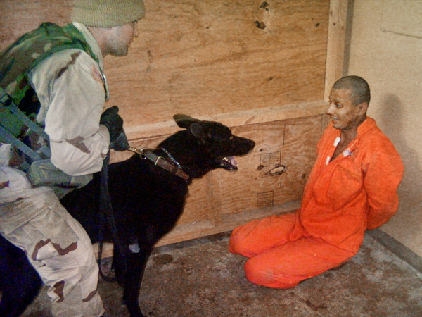 A prisoner being abused in Abu Ghraib prison.