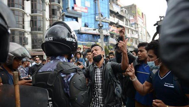Survivors of the Nepal earthquake clash with riot police in Nepal's capitol city, Kathmandu. 
