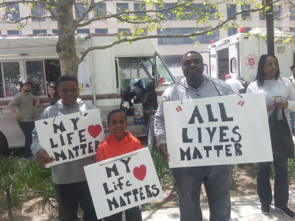 A man with his sons at the CIty Hall rally in Baltimore, May 2. 