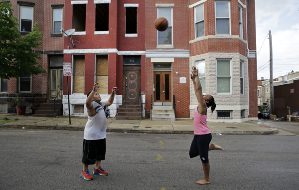 Baltimore, in front of a vacant home