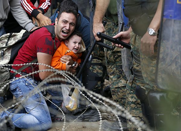 On August 21, photographer Georgi Licovski documented a brutal attack on migrants attempting to get out of Greece, where they are subjected to hate and concentration camps. The migrants were heading towards hoped-for sanctuary in northern Europe. But as they attempted to cross the border from Greece into neighboring Macedonia, police there fired tear gas and stun grenades to drive them back into Greece. Licovski said babies, children, and mothers were among those gassed and beaten, and that families were split up in the chaos. 