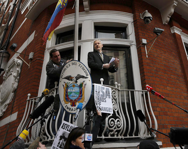 Julian Assange speaks to journalists and supporters from the balcony of the ecuadorian embassy in London, Friday, Feb. 5, 2016. 