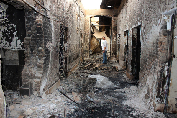 An employee of Doctors Without Borders stands inside the charred remains of their hospital after it was hit by a U.S. airstrike in Kunduz, Afghanistan, October 2015. AP photo