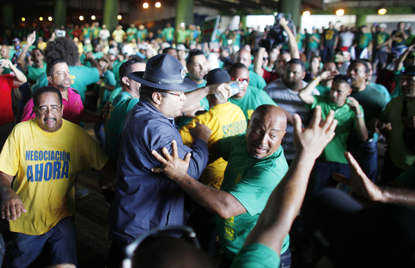 Blocking a main entrance tunnel, to protest austerity measures in San Juan, Puerto Rico, June 2014.  (AP Photo)