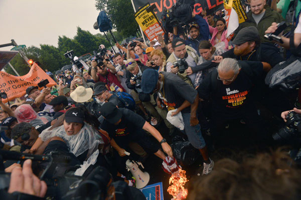 American Flag Burns at DNC! Carl Dix, Joey Johnson, Revolution Club Declare: "AMERICAN LIVES ARE NOT MORE IMPORTANT THAN OTHER PEOPLE'S LIVES" Photo: Nicholas Isabella