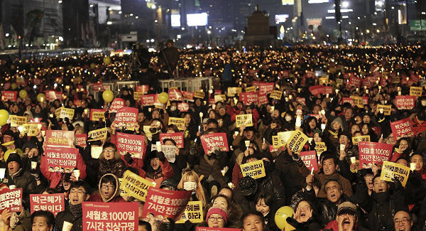 Protesters call for impeached President Park Geun-hye to step down during a candle light vigil in Seoul, South Korea, January 7.
