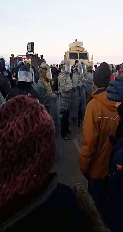 Supporters of the new camp at Standing Rock (left) confront militarized police who made over 70 arrests.