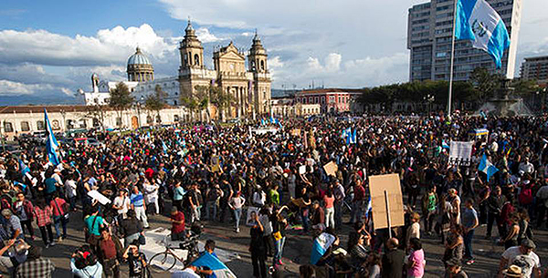 Thousands of Guatemalans protest in front of the National Palace in Guatemala City March 12, demanding justice for the 40 girls who burned to death in a government-run shelter.