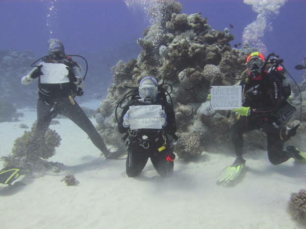 Scientists participate in March for Science underwater at Wake Atoll