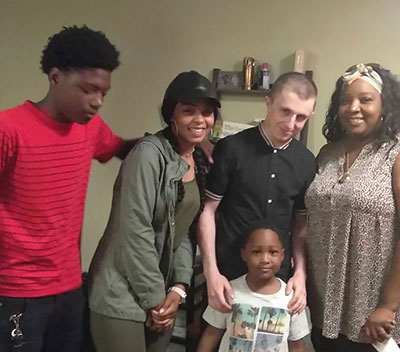 Micah Fletcher with family of one of the victims