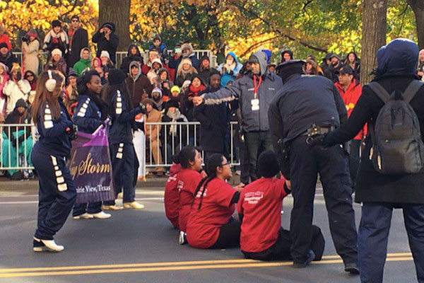 Sitting down in the street at the Thanksgiving Day Parade.