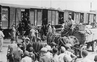 Jews from the Lodz ghetto being loaded onto freight trains for deportation to the Chelmno killing center. Lodz, Poland, between 1942 and 1944.